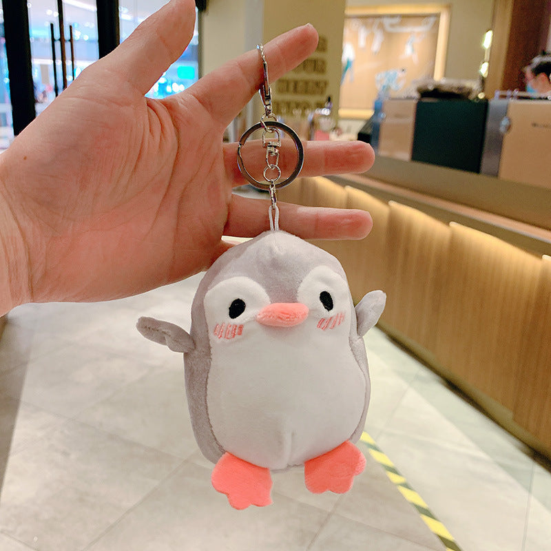 Cute Penguin plush keychain — light pink penguin, attached to school bag demo